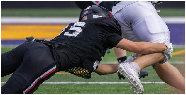 A football player is sliding on the ground. Description generated by AI