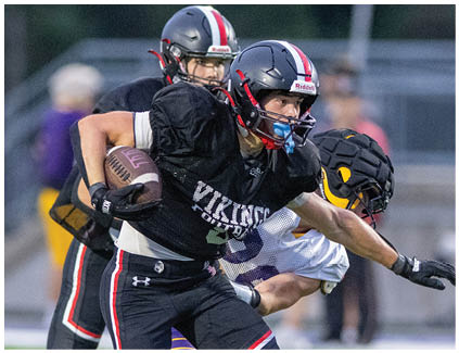 A football player in a black jersey with the number 2 on it. Description generated by AI