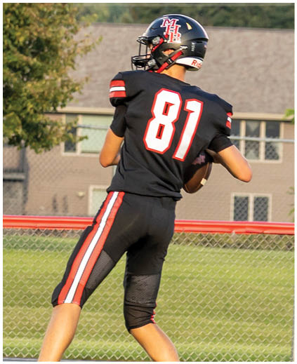 Two football players on a field. Description generated by AI