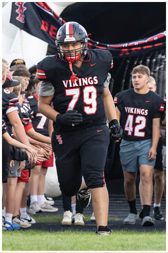 A football player wearing a black jersey with the number 78. Description generated by AI