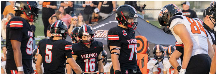 A group of football players in black and white uniforms. Description generated by AI