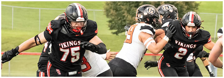 A football player is trying to tackle another player. Description generated by AI