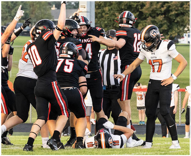 A group of football players celebrating a touchdown. Description generated by AI