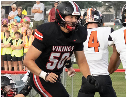 A football player wearing a black jersey with the number 50. Description generated by AI