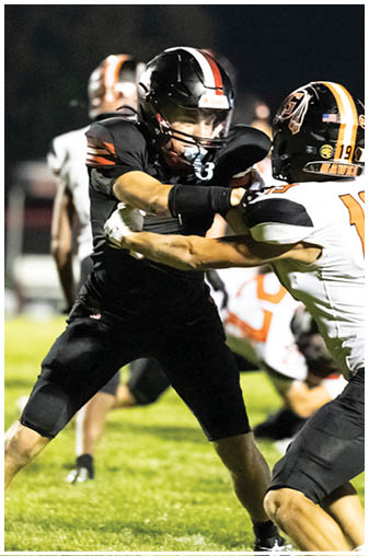 Two football players on the field. Description generated by AI