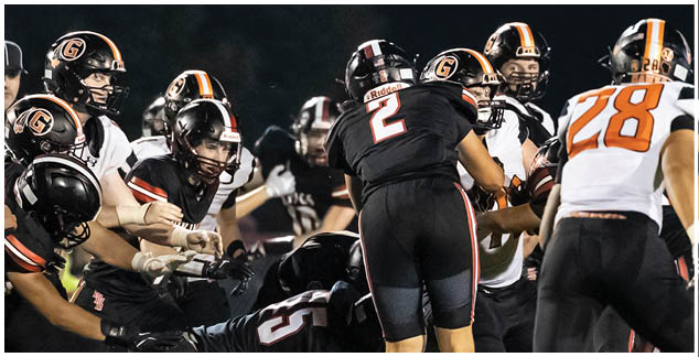 A group of football players on the field. Description generated by AI