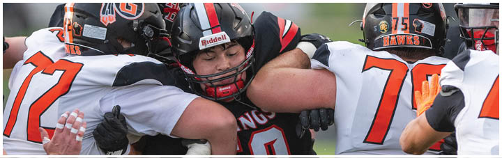 A group of football players in black and white uniforms. Description generated by AI