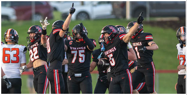 A group of football players celebrating a touchdown. Description generated by AI
