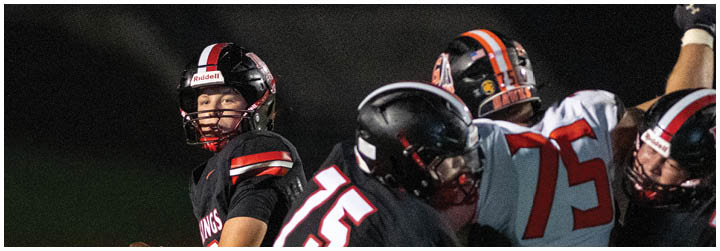 A football player wearing a black jersey with the number 15 on it. Description generated by AI