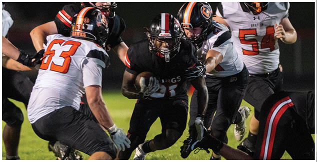 A football player is running with the ball. Description generated by AI