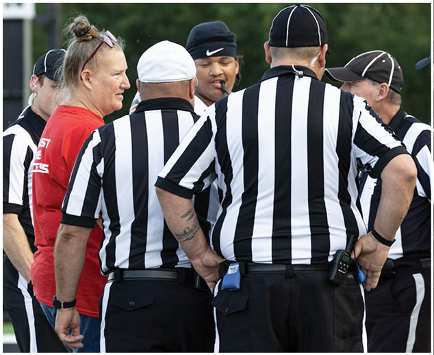 A group of people wearing black and white shirts. Description generated by AI