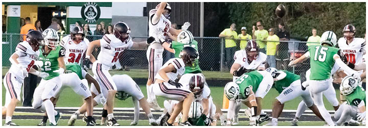 A group of football players on a field. Description generated by AI