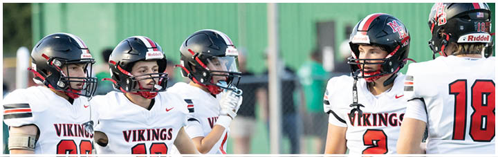 A group of football players wearing white jerseys with the number 21 on them. Description generated by AI