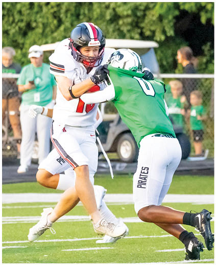 Two football players on the field. Description generated by AI