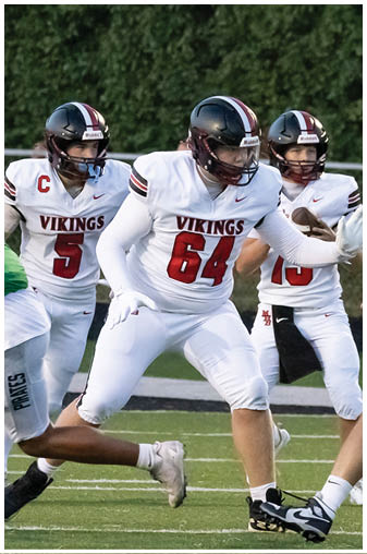 A football player wearing a white jersey with the number 61 on it. Description generated by AI