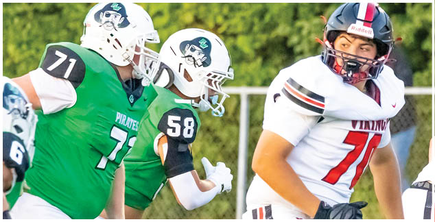 A football player in a green jersey is tackling another player. Description generated by AI