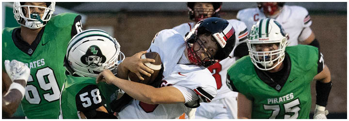 Two football players are fighting for the ball. Description generated by AI