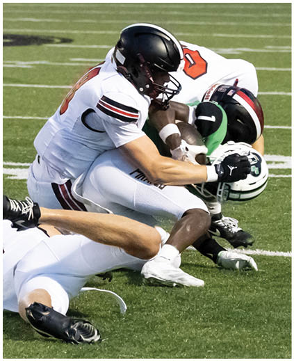 Two football players on the ground. Description generated by AI