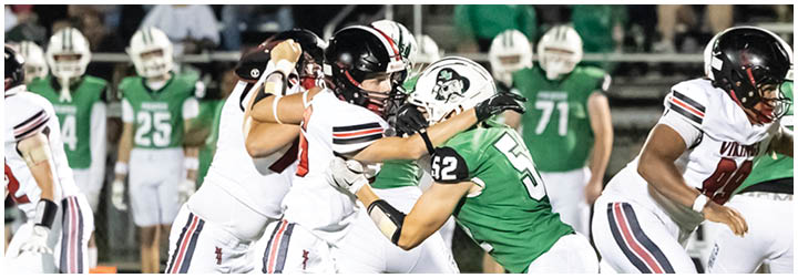A football game is taking place with two teams playing. Description generated by AI