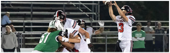 A football player in a white jersey is about to throw the ball. Description generated by AI