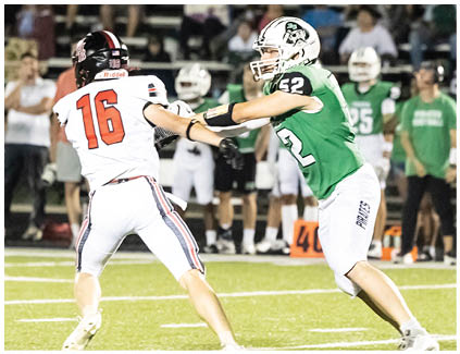 Two football players on a field. Description generated by AI