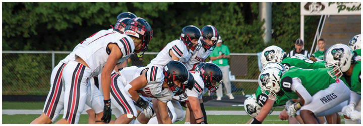 A group of football players in white and black uniforms. Description generated by AI
