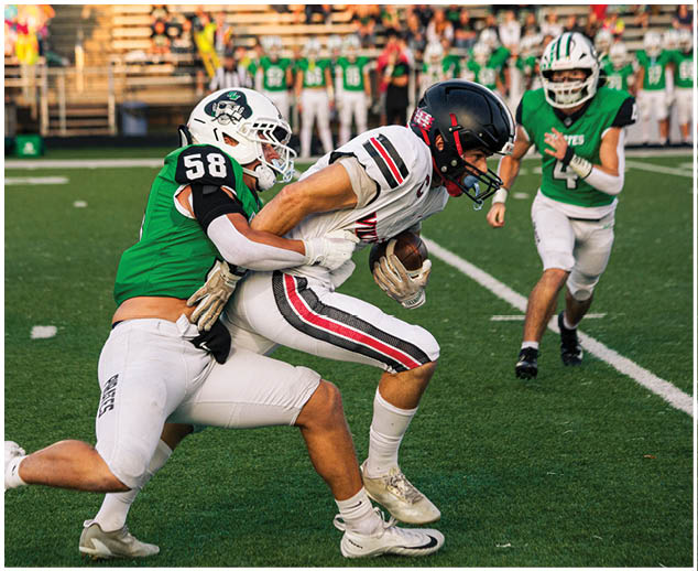 Two football players on the field. Description generated by AI