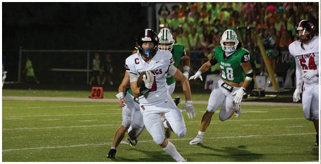 A football player running on the field. Description generated by AI
