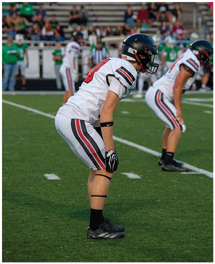 Two football players on the field. Description generated by AI