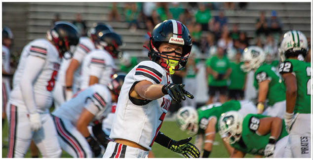 A football player wearing a white jersey with the number 22 on it. Description generated by AI