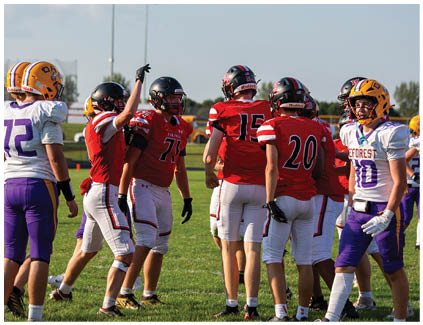 A group of football players wearing red and white uniforms. Description generated by AI