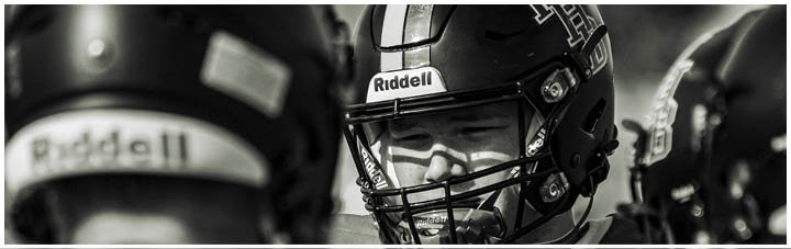 A football player wearing a helmet with the number 1 on it. Description generated by AI