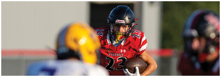 A football player in a red jersey with the number 42 on it. Description generated by AI