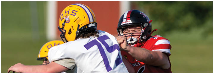 A football player wearing a red jersey with the number 6 on it. Description generated by AI