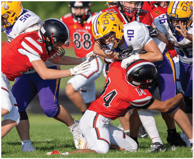 A group of football players on a field. Description generated by AI