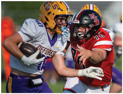 A football player wearing a red jersey with the number 17. Description generated by AI