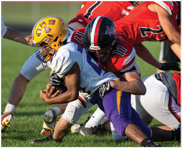 A group of football players on a field. Description generated by AI