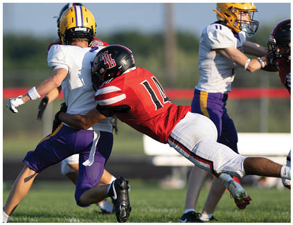 A football player is sliding on the ground. Description generated by AI