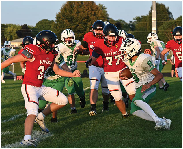 A group of football players on a field. Description generated by AI
