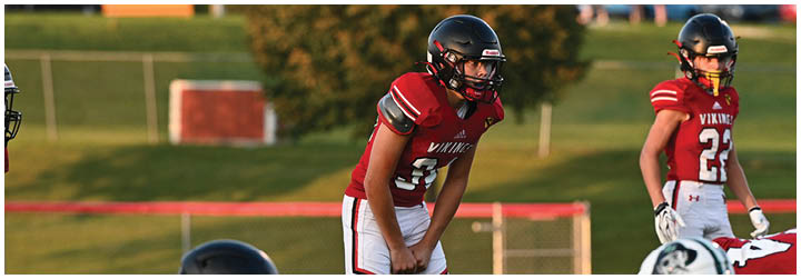 A group of football players in red and white uniforms. Description generated by AI