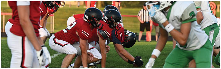 A group of football players on a field. Description generated by AI