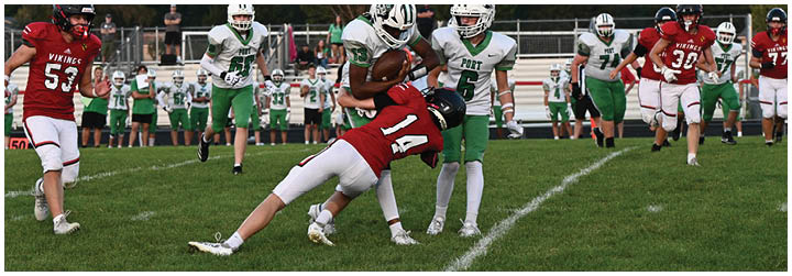 A football player is tackled to the ground. Description generated by AI