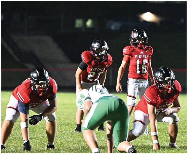 A group of football players on the field. Description generated by AI