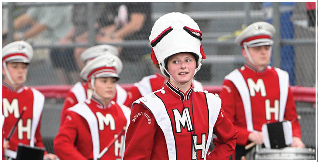 A group of people wearing red and white uniforms. Description generated by AI
