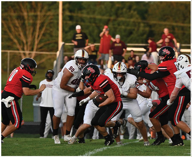 A group of football players on a field. Description generated by AI