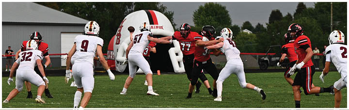 A group of football players on a field. Description generated by AI