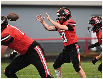 Two football players are playing in a game. Description generated by AI