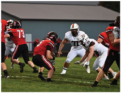A football game is taking place with players on the field. Description generated by AI