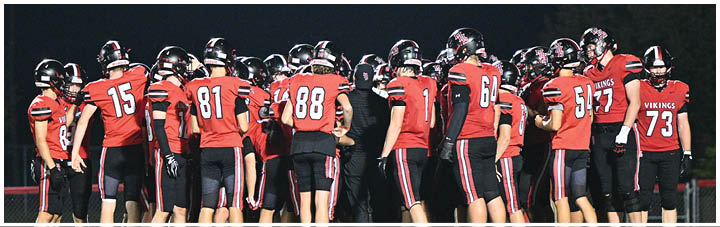 A group of football players on a field. Description generated by AI
