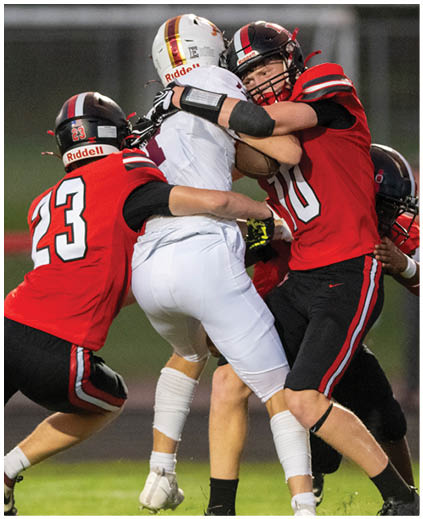 A group of football players on a field. Description generated by AI